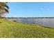 Scenic view of a tranquil lake with lush green landscaping at 13215 Amerigo Ln, Venice, FL 34293