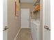 Convenient laundry room with washer, dryer, and shelving at 13215 Amerigo Ln, Venice, FL 34293