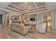 Living room with coffered ceiling and access to kitchen at 13215 Amerigo Ln, Venice, FL 34293