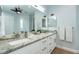 Bright bathroom featuring double sinks, a granite countertop, and modern fixtures at 180 Rotonda N Blvd, Rotonda West, FL 33947