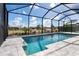 Sparkling pool with clear blue water surrounded by a screened enclosure and paver deck at 180 Rotonda N Blvd, Rotonda West, FL 33947