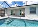 Exterior pool area featuring a screened-in patio, access to the home, and steps into the refreshing pool at 180 Rotonda N Blvd, Rotonda West, FL 33947