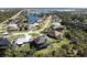 Aerial view of a residential neighborhood with various houses and a lake at 2213 Oleada Ct, Englewood, FL 34224