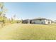 Large backyard with grassy area and screened enclosure at 2213 Oleada Ct, Englewood, FL 34224