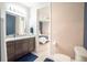 Clean bathroom with dark vanity, toilet and a view into the bedroom at 2213 Oleada Ct, Englewood, FL 34224