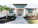 Inviting home exterior with landscaped walkway and blue accents at 2213 Oleada Ct, Englewood, FL 34224