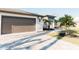 Brown double-car garage with paved driveway at 2213 Oleada Ct, Englewood, FL 34224