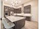 Modern kitchen with large island, stainless steel appliances, and dark cabinetry at 2213 Oleada Ct, Englewood, FL 34224