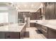 Modern kitchen with large island, stainless steel appliances, and dark cabinetry at 2213 Oleada Ct, Englewood, FL 34224