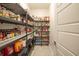 Well-stocked pantry with ample shelving for storage at 2213 Oleada Ct, Englewood, FL 34224