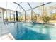 Relaxing screened-in pool with waterfall feature at 2213 Oleada Ct, Englewood, FL 34224