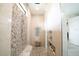 Large walk-in shower with pebble tile and built-in seating at 2213 Oleada Ct, Englewood, FL 34224