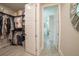 Spacious walk-in closet with ample storage and access to bathroom at 2213 Oleada Ct, Englewood, FL 34224