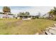 Backyard view of house with screened porch and canal access at 446 Court St, Englewood, FL 34223