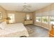 Bedroom features ceiling fan, two windows, a dresser, and light-colored walls at 6113 Partridge Ave, Englewood, FL 34224