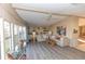 Cozy living room featuring large windows, built-in shelving, and comfortable seating at 6113 Partridge Ave, Englewood, FL 34224