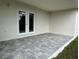 Covered back patio with paver stones and double doors at 9992 Antler St, Port Charlotte, FL 33981