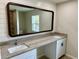 Elegant bathroom with double sinks, granite countertop, and large mirror at 9992 Antler St, Port Charlotte, FL 33981