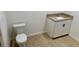 Simple toilet and vanity with granite countertop at 9992 Antler St, Port Charlotte, FL 33981