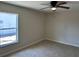 Bright bedroom with ceiling fan and large window at 9992 Antler St, Port Charlotte, FL 33981