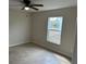 Spacious bedroom with ceiling fan and large window at 9992 Antler St, Port Charlotte, FL 33981