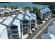 Aerial view of white condos with metal roofs near a body of water at 2255 N Beach Rd # 9, Englewood, FL 34223