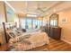 Spacious bedroom features a king bed, ceiling fan, and balcony with beach views at 2255 N Beach Rd # 9, Englewood, FL 34223