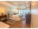 Bedroom featuring a king bed, ceiling fan, and balcony with beach views at 2255 N Beach Rd # 9, Englewood, FL 34223