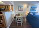 Cozy dining area with a dark wood table, seating for four, and nautical-themed decor at 2255 N Beach Rd # 9, Englewood, FL 34223
