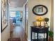 View of the hallway with wood floors that extends to the living area with sliding glass doors at 2255 N Beach Rd # 9, Englewood, FL 34223