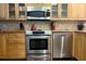 Kitchen featuring wooden cabinets, stainless steel appliances, and a tile backsplash at 2255 N Beach Rd # 9, Englewood, FL 34223