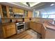 Open kitchen featuring wooden cabinets, stainless steel appliances, and a tile backsplash at 2255 N Beach Rd # 9, Englewood, FL 34223