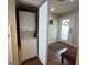 Laundry room with a stacked washer and dryer, and access to an entryway at 2255 N Beach Rd # 9, Englewood, FL 34223