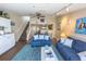 Comfortable living room with two blue sofas, a blue rug, and stairs leading to the upper floor at 2255 N Beach Rd # 9, Englewood, FL 34223