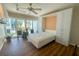 Bedroom with a murphy bed, ceiling fan, and sliding glass doors to a balcony at 2255 N Beach Rd # 9, Englewood, FL 34223