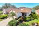 Single-story home with a tile roof, two-car garage, and lush landscaping at 3238 Osprey Ln, Port Charlotte, FL 33953