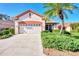 Front view of a single story house with a two car garage and driveway at 3238 Osprey Ln, Port Charlotte, FL 33953