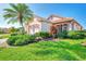 Well-maintained house with a palm tree and manicured lawn at 3238 Osprey Ln, Port Charlotte, FL 33953