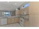 Bright kitchen with ample cabinetry, white appliances, and a view to the backyard at 3238 Osprey Ln, Port Charlotte, FL 33953