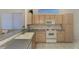 Kitchen boasts light wood cabinets, a double sink, and a tile floor at 3238 Osprey Ln, Port Charlotte, FL 33953