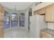 Kitchen nook with large windows, light tile floors, and a view to the backyard at 3238 Osprey Ln, Port Charlotte, FL 33953