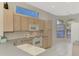 Bright kitchen with ample cabinetry, white appliances, and a view to the backyard at 3238 Osprey Ln, Port Charlotte, FL 33953