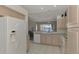 Kitchen features white appliances, light wood cabinets, and a view to the Gathering room at 3238 Osprey Ln, Port Charlotte, FL 33953