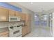 Bright kitchen with ample cabinetry, white appliances, and a view to the backyard at 3238 Osprey Ln, Port Charlotte, FL 33953