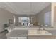 Kitchen features a double sink, gray countertops, and a view into the living room and backyard at 3238 Osprey Ln, Port Charlotte, FL 33953