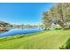 Serene lake view from backyard, green grass at 3238 Osprey Ln, Port Charlotte, FL 33953