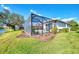 Enclosed pool area with lake view in backyard at 3238 Osprey Ln, Port Charlotte, FL 33953
