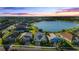 Aerial view of a luxury home community with lake and fountain at 11564 Renaissance Blvd, Venice, FL 34293