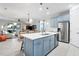 Modern kitchen with light blue cabinets and large island at 11564 Renaissance Blvd, Venice, FL 34293