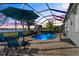 Relaxing pool area with covered patio and lake view at 11564 Renaissance Blvd, Venice, FL 34293